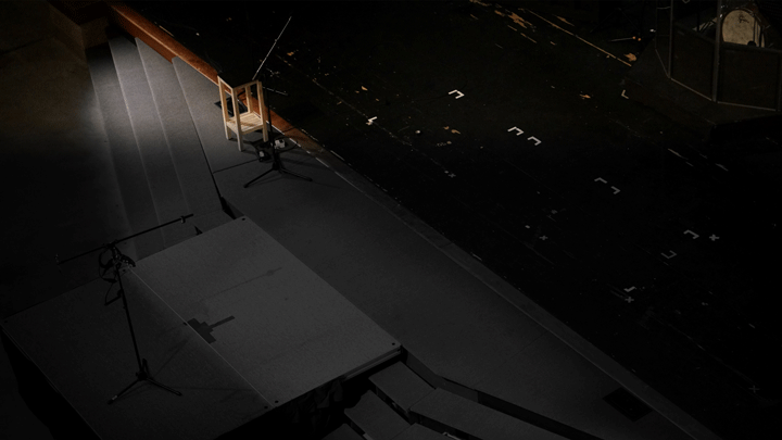 A chair on a stageAI-generated content may be incorrect.